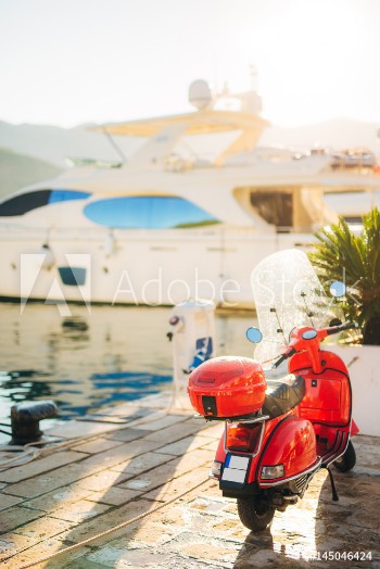 Bild på A red retro moped parked at the marina In Budva Montenegro